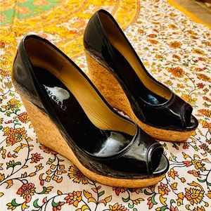 Size 37.5 (US 7.5) Jimmy Choo black patent leather peep toe cork wedge heels.